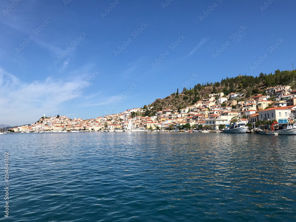 view from the yacht to the island with the traditional architecture in the Greek style. entry into the bay