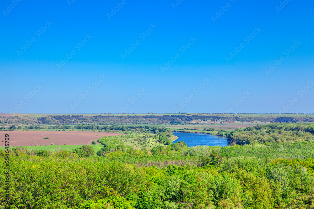 Aerial view of tranquil winding river , amid lush green landscape 