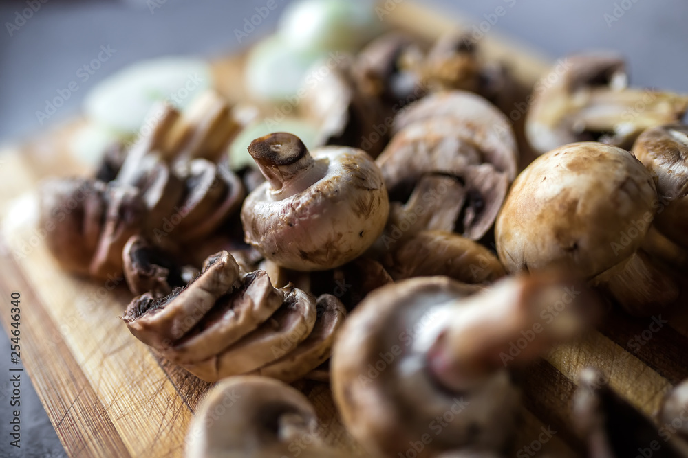 Champignon mushrooms on kitchen desk prepared to cook vegetarian healthy food. Vegan natural food concept Champignon mushrooms on kitchen desk prepared to cook vegetarian healthy food. Vegan natural food concept