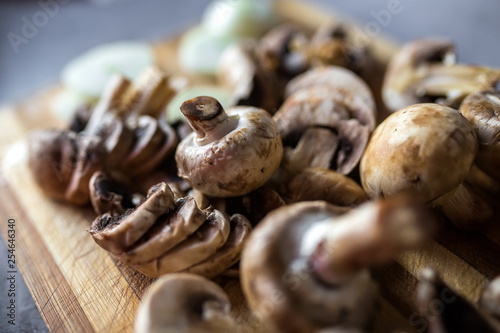 Fototapeta Naklejka Na Ścianę i Meble -  Champignon mushrooms on kitchen desk prepared to cook vegetarian healthy food. Vegan natural food concept