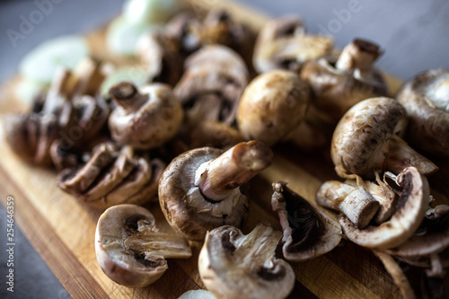 Champignon mushrooms on kitchen desk prepared to cook vegetarian healthy food. Vegan natural food concept