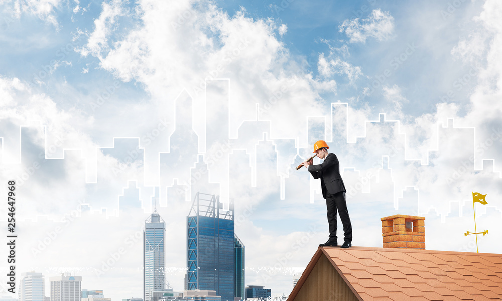 Engineer man standing on roof and looking in spyglass. Mixed media Engineer man standing on roof and looking in spyglass. Mixed media