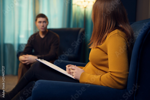 Picture of woman psychologist and man at consultation.