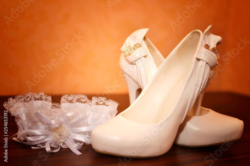 Wedding background of shoes and garter of the bride