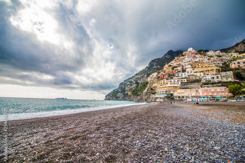 Panoramic view of the beach with colorful buildings of Positano, Italy.