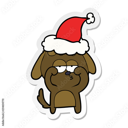sticker cartoon of a tired dog wearing santa hat © lineartestpilot