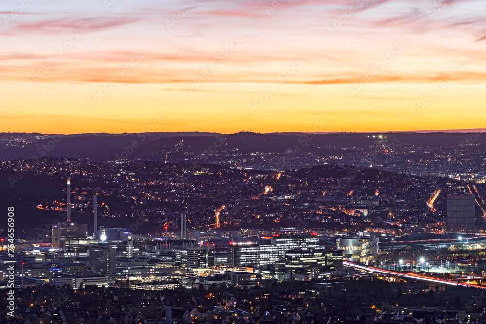City lights of Stuttgart (Germany) after sunset from above. The industrialized valley of the river Neckar in the foreground.