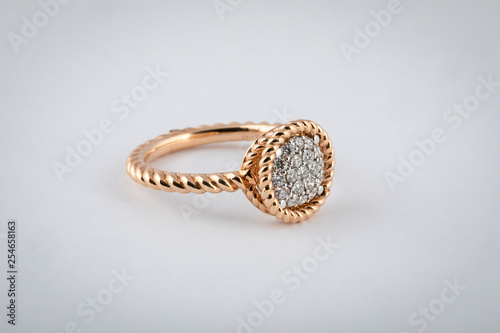 Women's gold ring with diamonds in the middle, isolated on a white background. photo