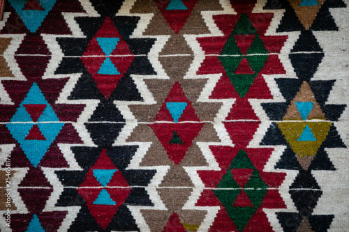 Hand-woven carpet with traditional patterns.