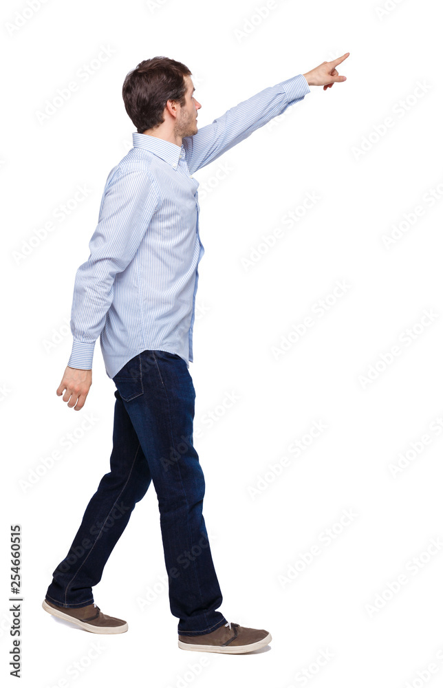 Back view of a man walking with a pointing hand. Back view of a man walking with a pointing hand.