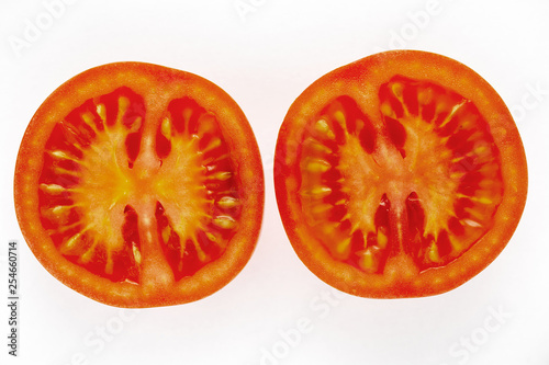 Close up shot of a red tomatoe on a white background