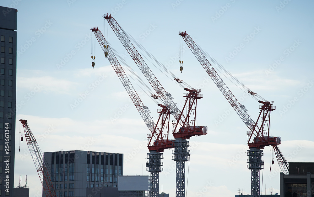 A sight of a blue sky and a crane on the construction site A sight of a blue sky and a crane on the construction site