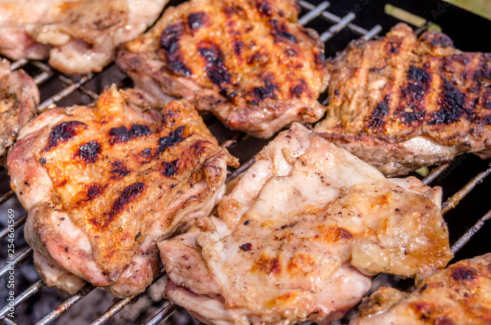 Chicken steak on the grill. Cooking chicken on the barbeque with charcoal in garden.