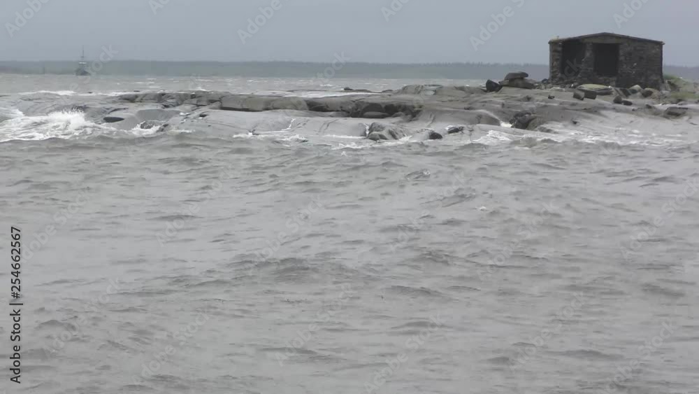 The strong waves of the White Sea crashing on the rocky shore The strong waves of the White Sea crashing on the rocky shore