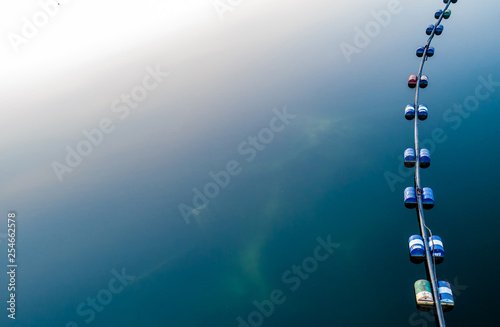 Aerial view of blue tube with barrels on the deep navy blue lake
