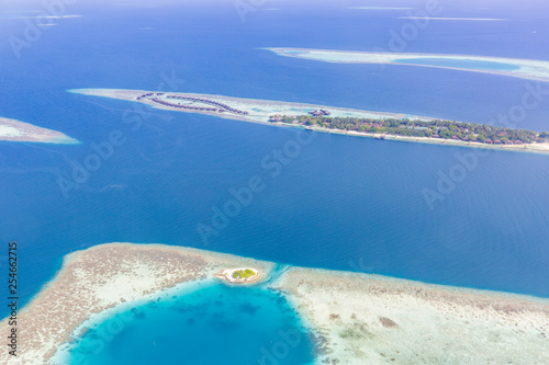 Fototapeta Naklejka Na Ścianę i Meble -  Maldives island and sea, aerial view of luxury resort with water villas and coral next to the island