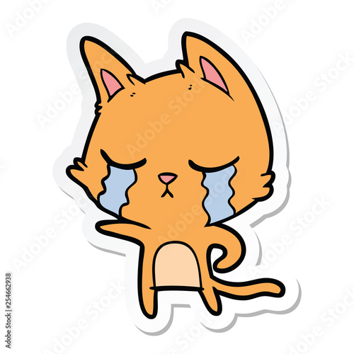 sticker of a crying cartoon cat pointing