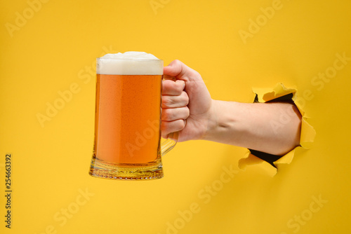 Hand holding a beer glass