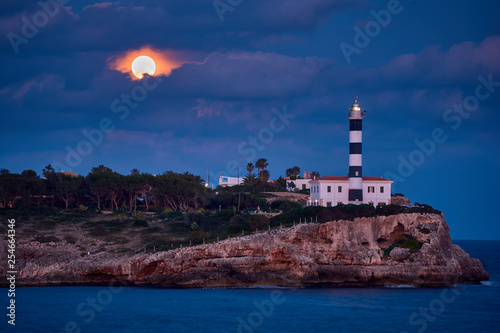 The Lighthouse and the moon. Portocolom, Spain. photo