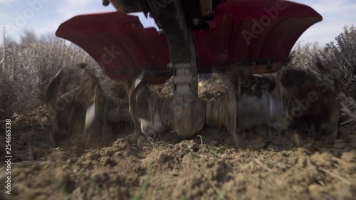 Farmer working with a tiller photo