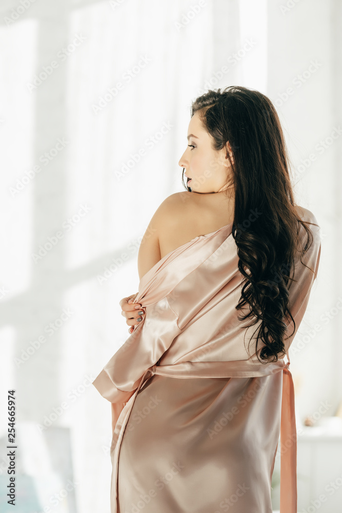 sexy brunette woman standing in silk robe at home Stock Photo | Adobe Stock