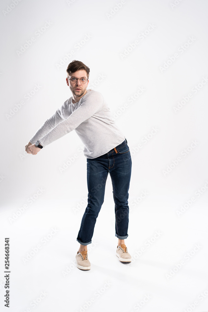 Funny man in casual is having some fun. He is posing and dancing. Isolated on white background. Funny man in casual is having some fun. He is posing and dancing. Isolated on white background.
