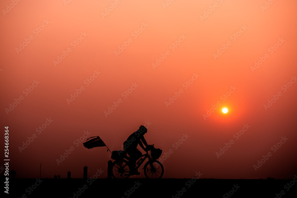 Obraz premium ride bicycle with sunset background.