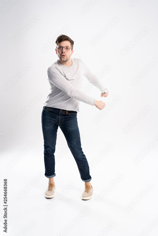 Funny man in casual is having some fun. He is posing and dancing. Isolated on white background. Funny man in casual is having some fun. He is posing and dancing. Isolated on white background.