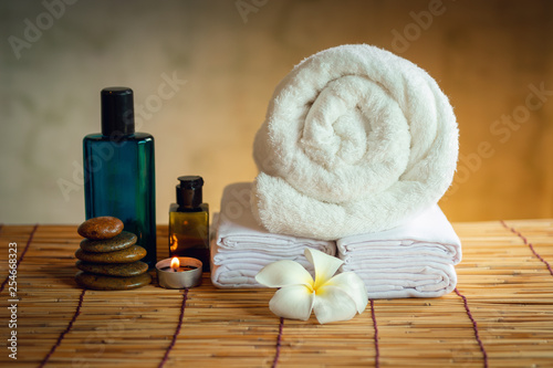 Spa Oil Massaging Treatment and Skincare Concept., Component of Therapy Massage With Plumeria or Frangipani Flowers, Towel, Stones, Aroma Candle and Oil on The Desk.