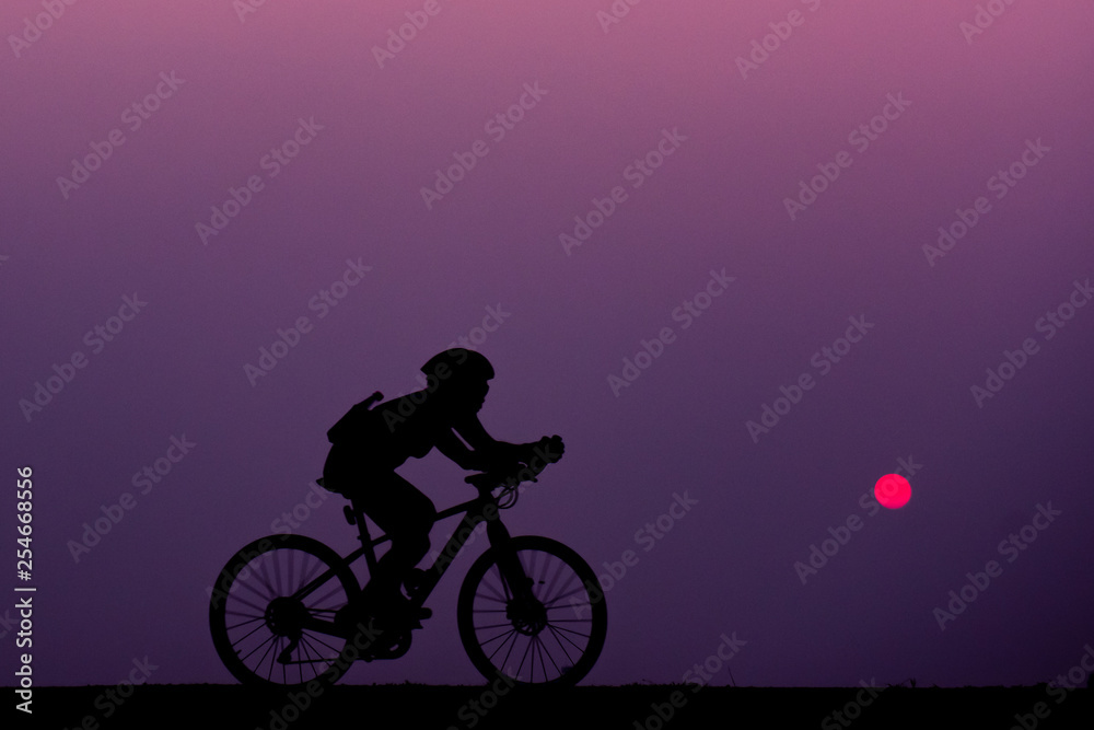 Fototapeta premium ride bicycle with sunset background.