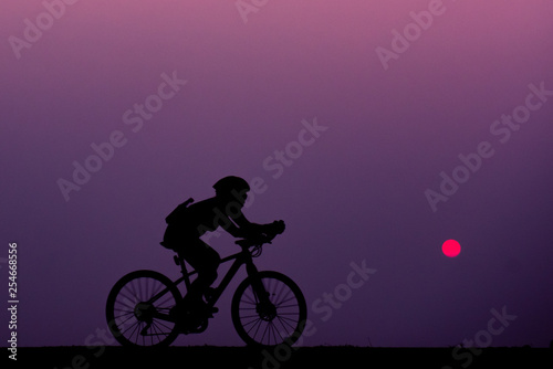 ride bicycle with sunset background. © watchara
