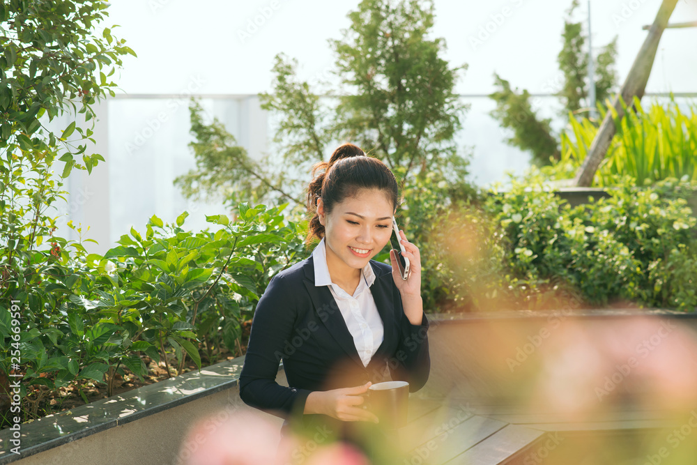 business woman use smartphone at the garden park business woman use smartphone at the garden park