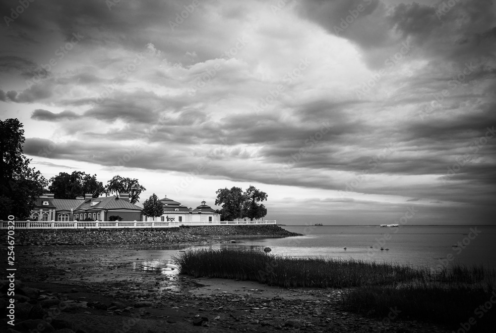 Old manor on the coast of the Gulf of Finland under dramatic thunderclouds. Peterhof. Russia.