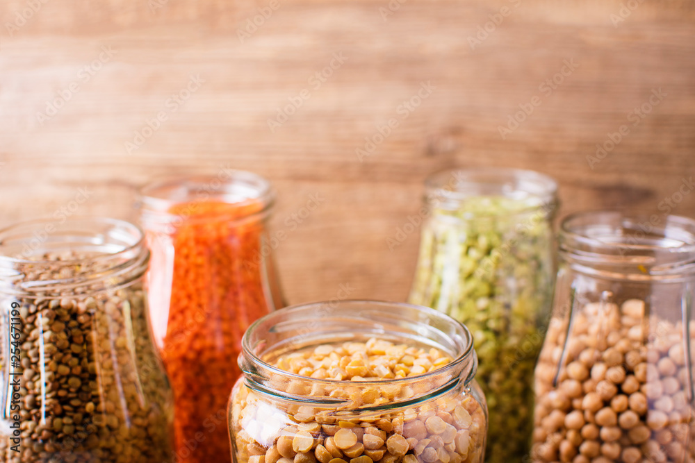 Assortment of dry organic beans and lentils in glass jars . Variety of raw legumes. Balanced diet, cooking, vegetarian and clean eating concept. Healthy food. Assortment of dry organic beans and lentils in glass jars . Variety of raw legumes. Balanced diet, cooking, vegetarian and clean eating concept. Healthy food.
