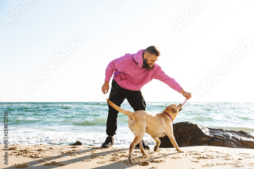 Man playing at the beach © Drobot Dean