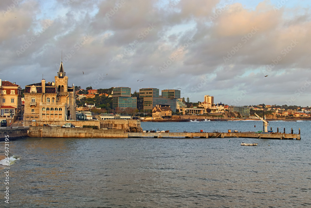 Panoramic view of famous touristic city ? Cascais. The city is located on the coast of Atlantic Ocean. Fishing port of Cascais in the foreground