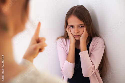 No more lecture - teenager girl covering her ears while her mother reprehend her