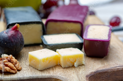 Mini black and dark red waxed cheddar cheeses made from West Country milk and and age-old methods in England