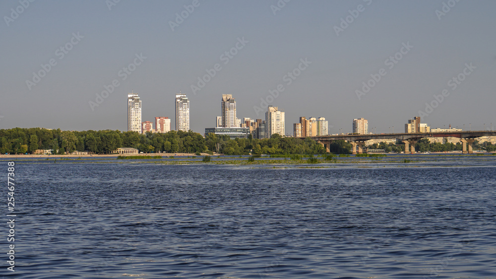 Beautiful river with a city on the other side. Beach in nature. stock photo