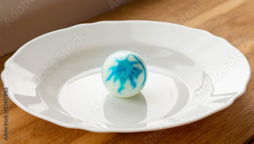 peeled dyed easter egg with traces of dye on egg white among other easter eggs, food dye safety