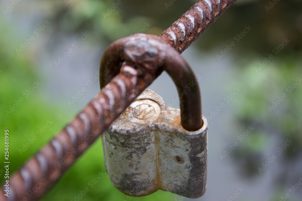 attached to welding, large padlock hanging on a suspension bridge attached to welding, large padlock hanging on a suspension bridge