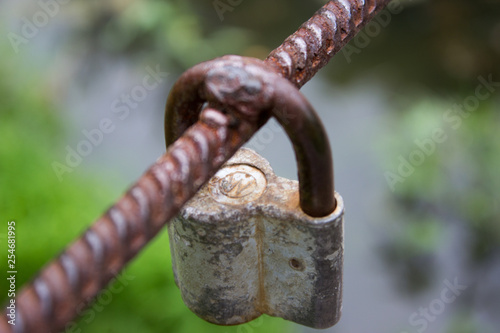 attached to welding, large padlock hanging on a suspension bridge