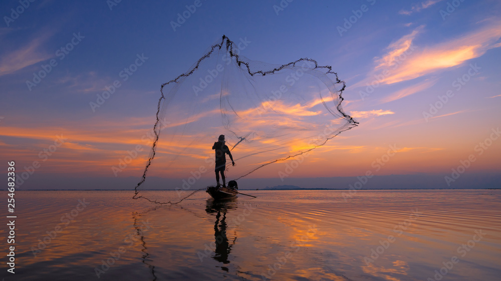 Silhouette Fisherman fishing nets on the boat. Silhouette of