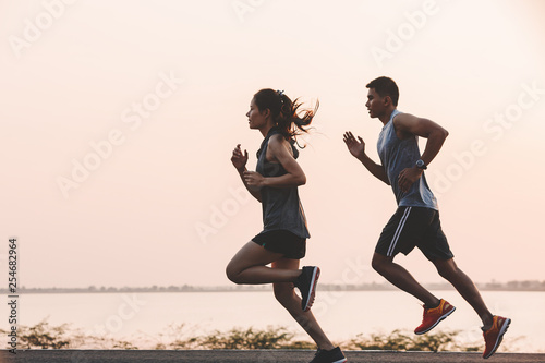 Fotografie, Obraz young couple runner running on running road in city park