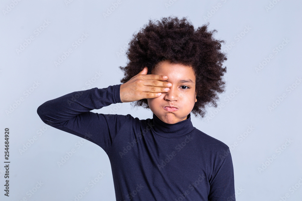 Funky dark-skinned little men inflating his cheeks and closing one eye Funky dark-skinned little men inflating his cheeks and closing one eye