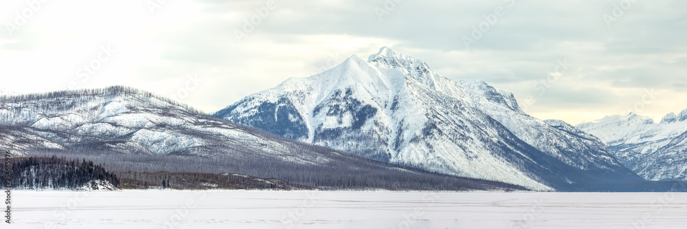 Snow covered mountains panorama overlooking Lake McDonald, Glacier National Park, Montana in winter