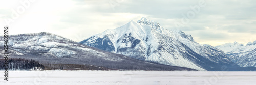 Snow covered mountains panorama overlooking Lake McDonald, Glacier National Park, Montana in winter photo