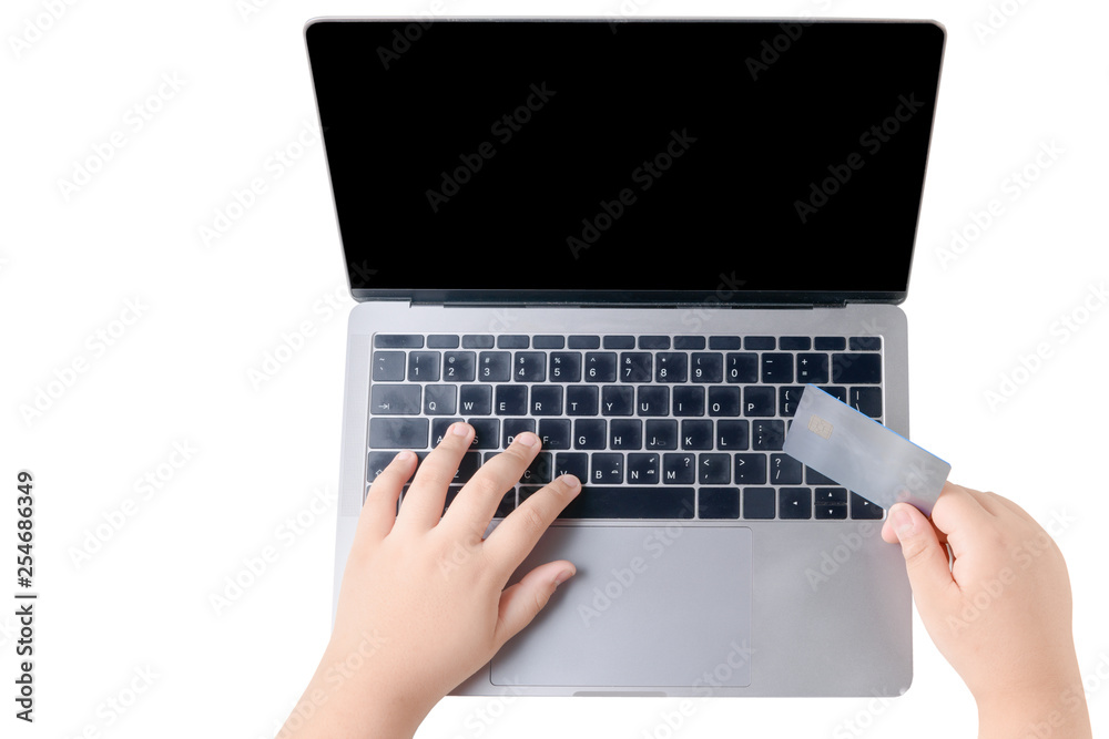 kid holding credit card on laptop isolated kid holding credit card on laptop isolated