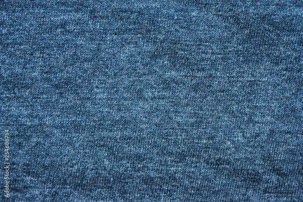Blue texture background of faded soft cotton shirt fabric surface. Empty cloth and plain cotton jersey design, flat lay top view of old navy blue solid clothing material Blue texture background of faded soft cotton shirt fabric surface. Empty cloth and plain cotton jersey design, flat lay top view of old navy blue solid clothing material