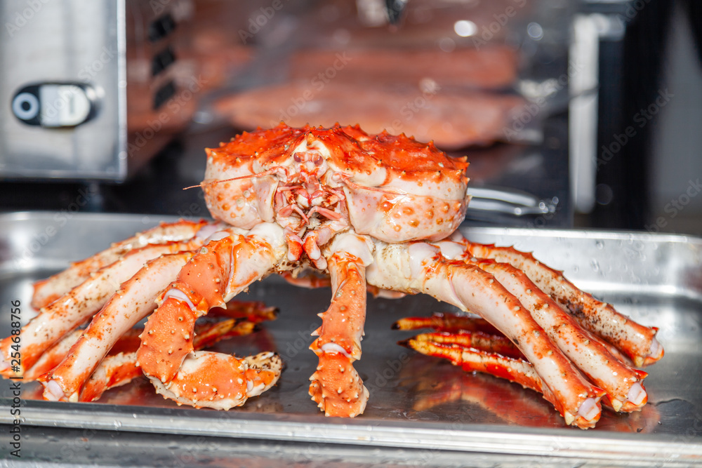 Carving fresh red big boiled prepared blue kamchatka crab. Concept useful seafood in menu, chef premium restaurant preparing crab for serving for guests, clients Carving fresh red big boiled prepared blue kamchatka crab. Concept useful seafood in menu, chef premium restaurant preparing crab for serving for guests, clients